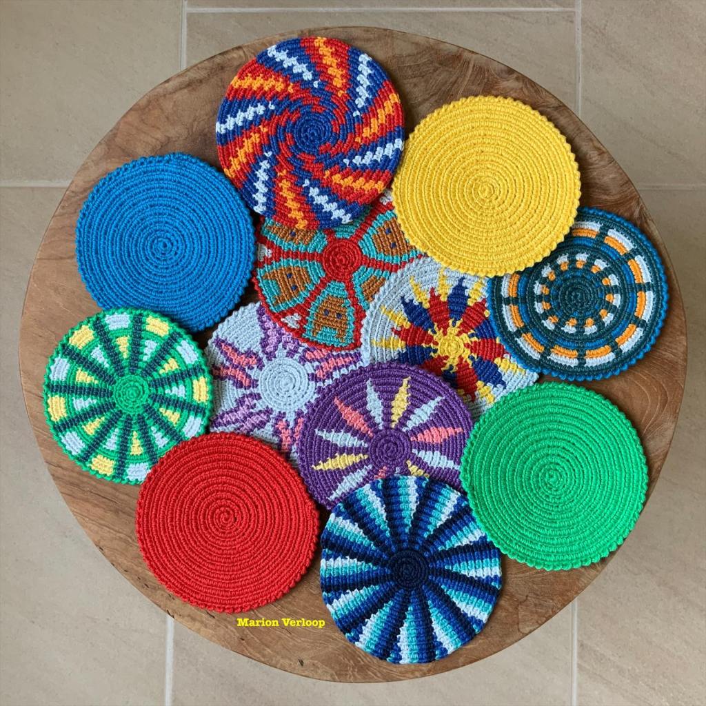 Set of colorful Mochila crochet coasters, featuring 8 unique patterns and 1 plain design, perfect for beginners.