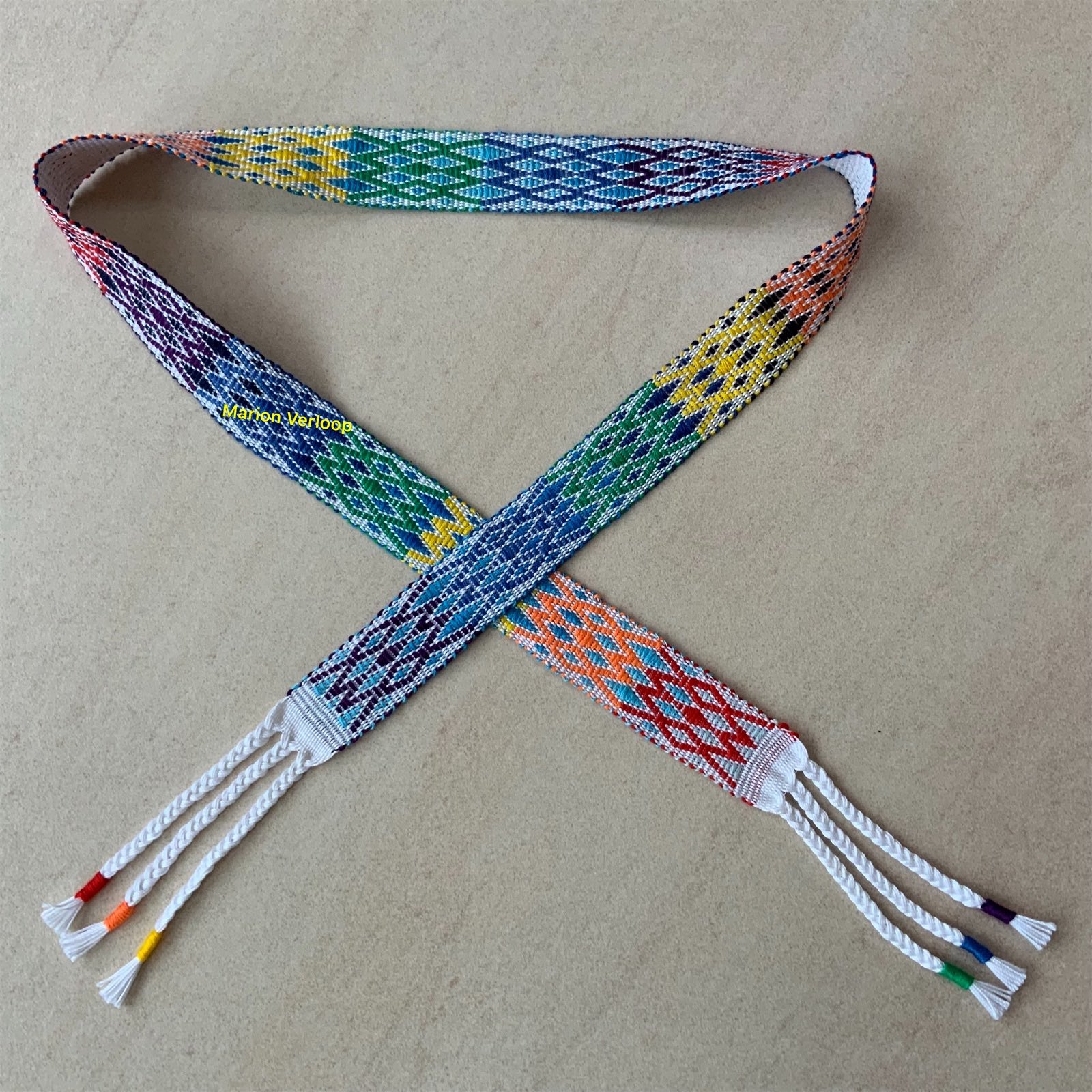 Cheerful woven band with a rainbow pattern, created using supplementary weft threads for added color and texture.